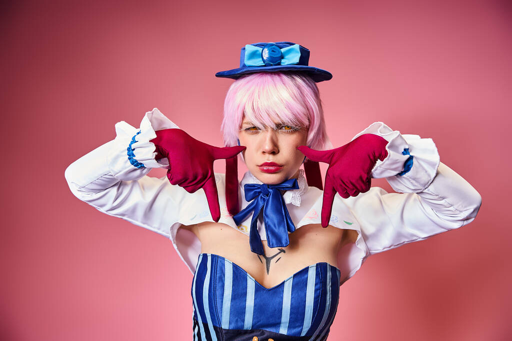 good looking sexy woman with red gloves and blue hat showing crying gesture on pink backdrop - Photo, Image