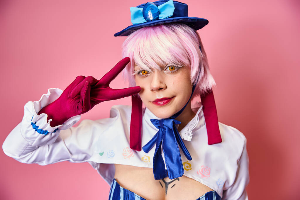 joyous young woman cosplaying anime character and showing peace gesture and looking at camera - Photo, Image
