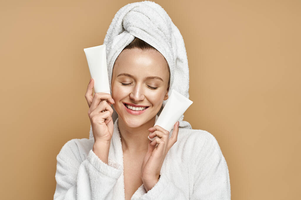 A woman in a bathrobe mysteriously holding a cream over her face, exuding elegance and allure. - Photo, Image
