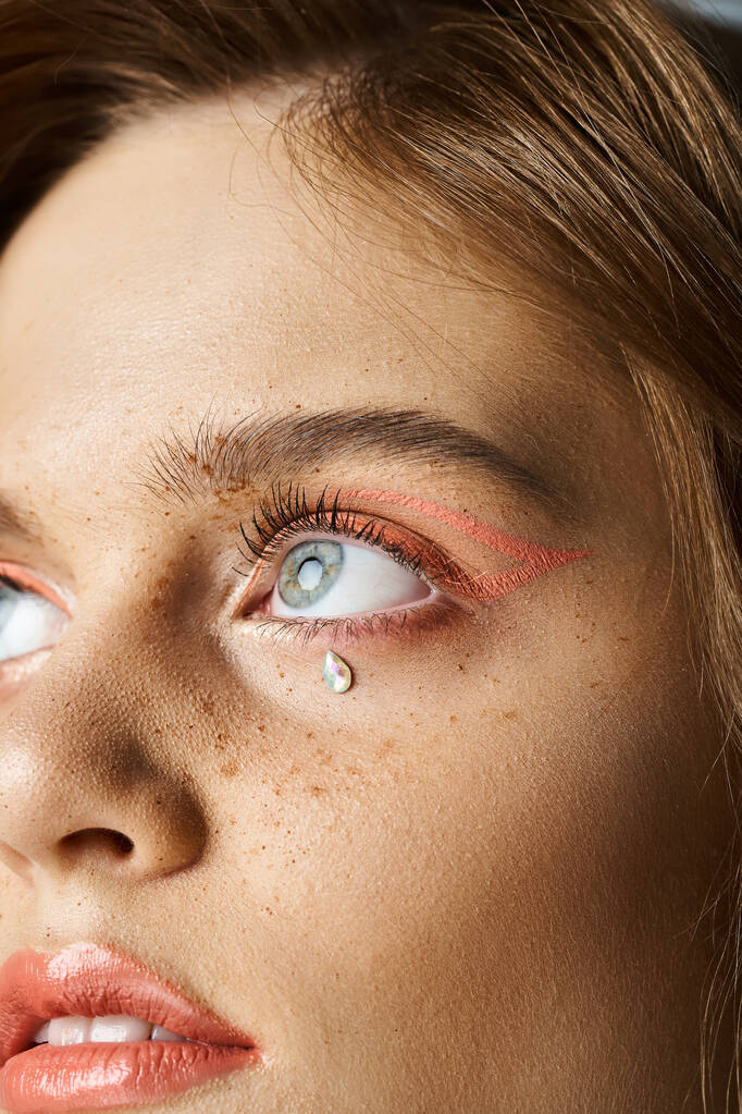 Крупный план красоты портрет женских глаз со слезовидными украшениями для лица, персиковый макияж и веснушки - Фото, изображение