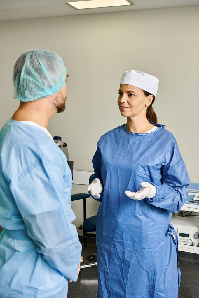 A man and woman in scrubs discussing laser vision correction. - Photo, Image