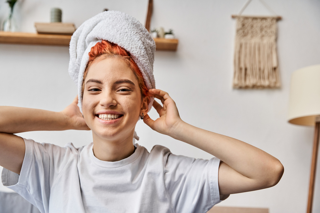beautiful positive queer person in homewear with hair towel looking at camera, morning routine - Photo, Image