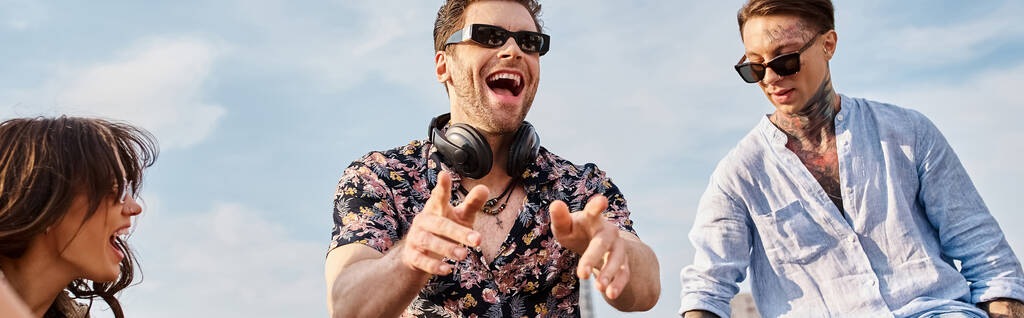 jolly attractive people in casual attires with sunglasses partying at rooftop to DJ set, banner - Photo, Image