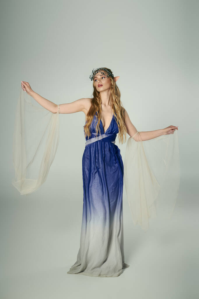 Młoda kobieta w niebiesko-białej sukience, ucieleśniająca istotę bajki lub elfowej księżniczki w wymarzonym, studyjnym otoczeniu. - Zdjęcie, obraz