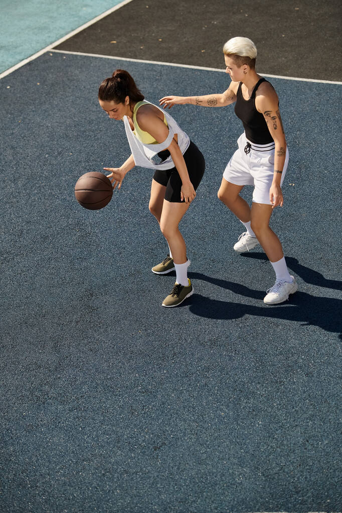 Δύο αθλήτριες στέκονται με αυτοπεποίθηση σε γήπεδο μπάσκετ.. - Φωτογραφία, εικόνα
