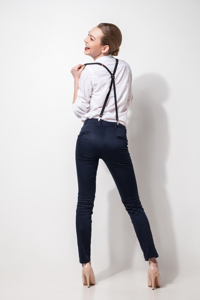 fashion model in black trousers and top posing over white. Back view - Photo, Image