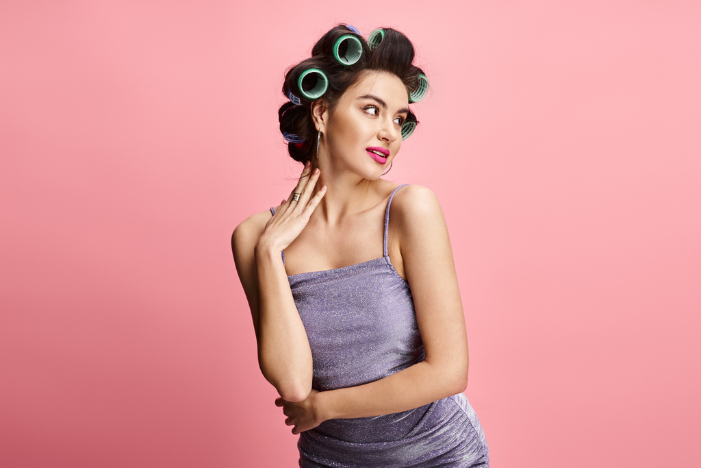 A stylish woman with curlers in her hair striking a pose. - Photo, Image