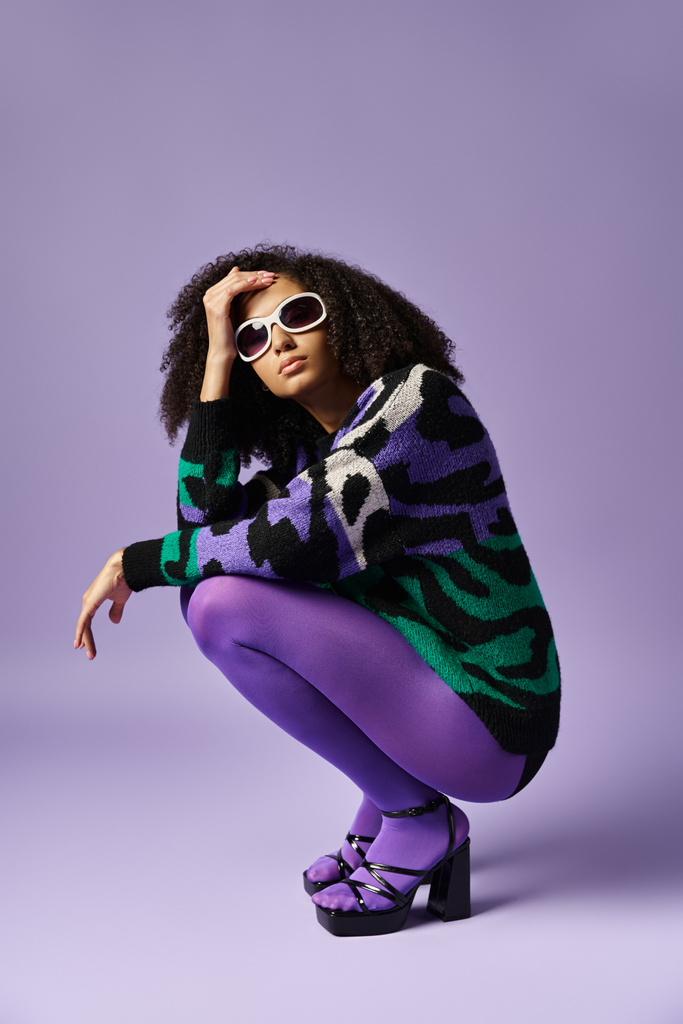 A young woman striking a pose in purple pants and a zebra-patterned sweater against a purple backdrop. - Photo, Image