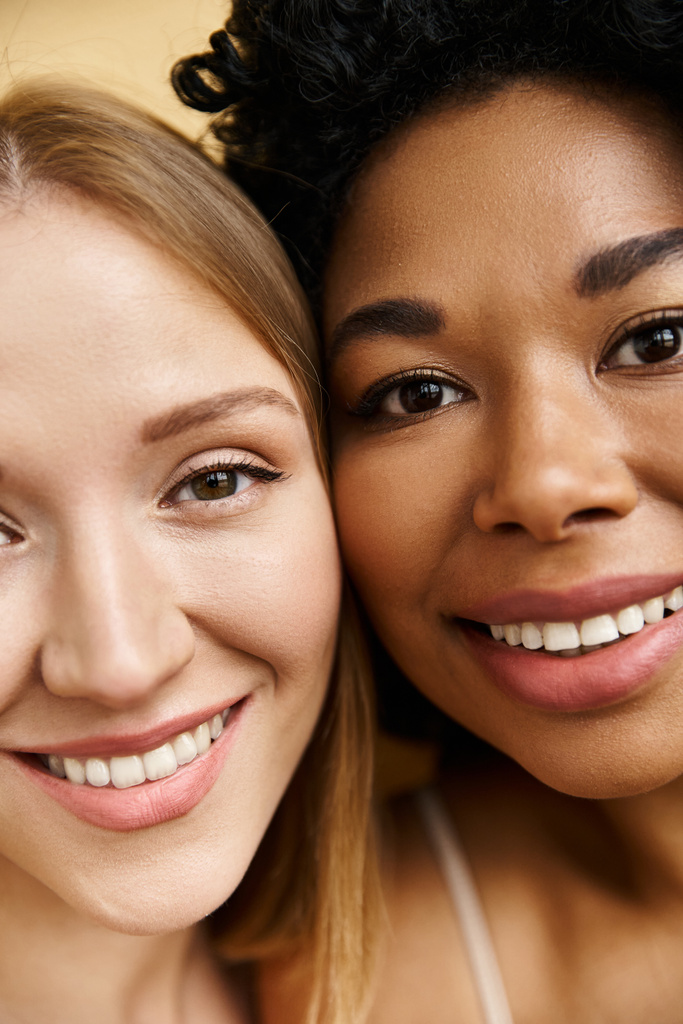 Dos hermosas mujeres diversas en ropa interior pastel acogedor sonriendo y posando para una imagen. - Foto, imagen