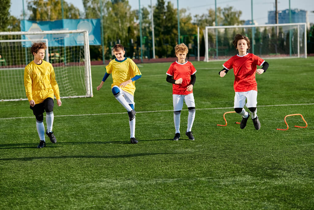 A vibrant scene unfolds as a group of young boys passionately play a game of soccer. The boys energetically chase the ball, make strategic passes, and attempt daring shots on goal in a spirited display of teamwork and athleticism. - Photo, Image