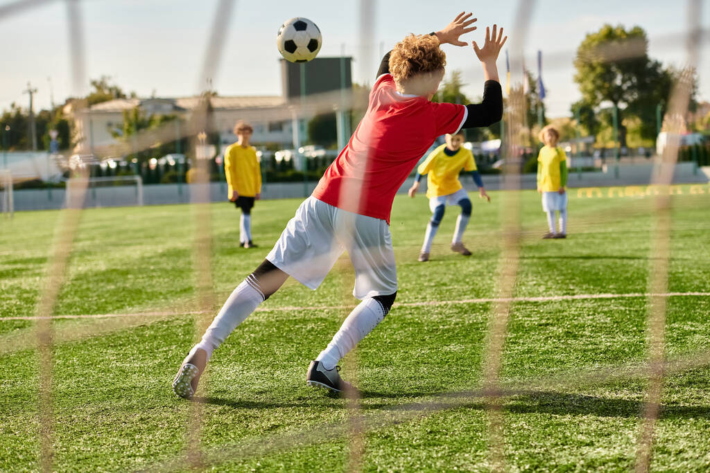 Dynamiczna scena rozwija się, gdy grupa młodych mężczyzn zaciekle rywalizuje w grze w piłkę nożną, biegając, mijając i strzelając do celu z niezaprzeczalną pasją i umiejętnościami. - Zdjęcie, obraz
