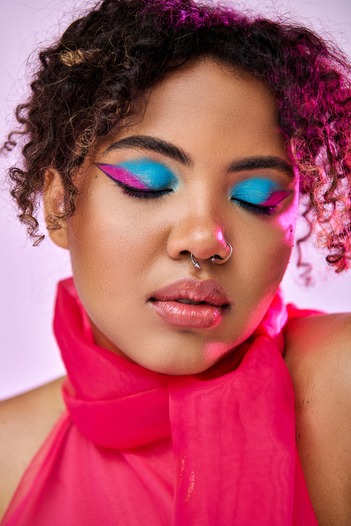 Beautiful African American woman poses with bright blue eye shadows. - Photo, Image