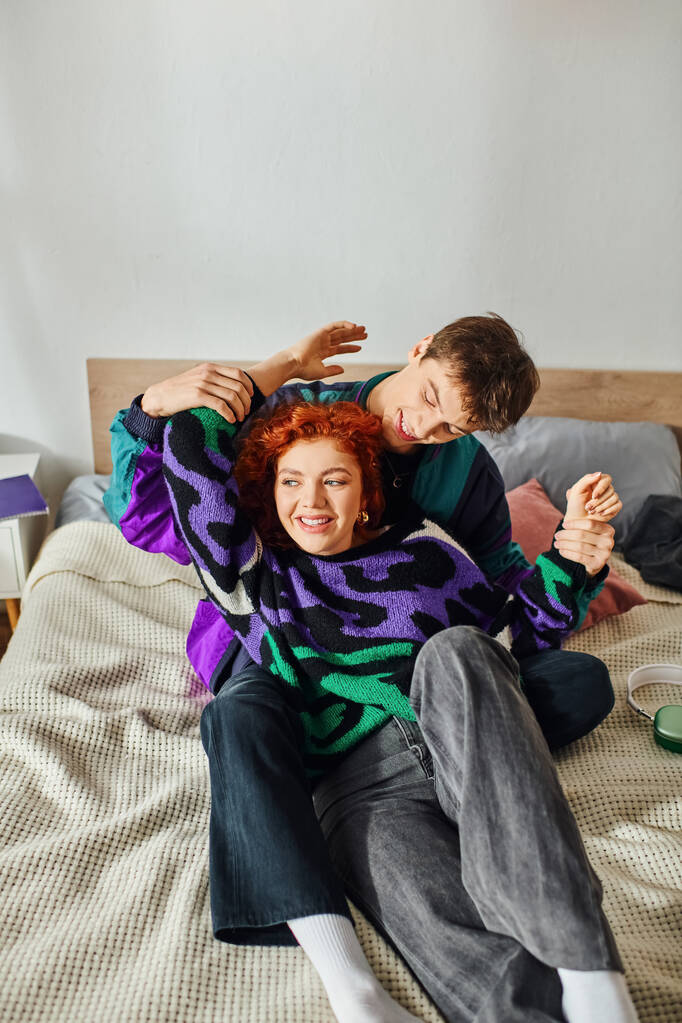 joyous attractive girlfriend and boyfriend having quality time together while lying in bed at home - Photo, Image