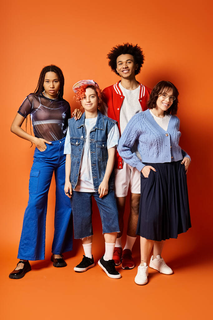 Jonge multiculturele vrienden, waaronder een niet-binaire persoon, die samen staan in stijlvolle kleding in een studio-omgeving. - Foto, afbeelding