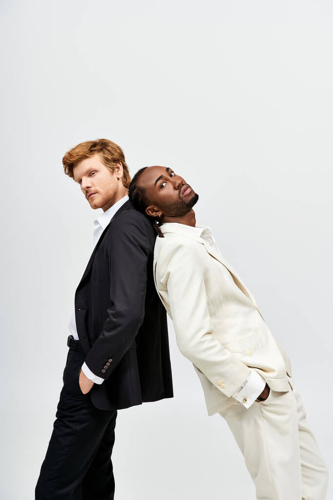 Handsome multicultural men in elegant suits pose together. - Photo, Image