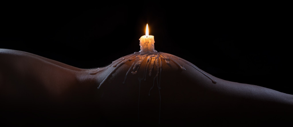 Body scape of a well-shaped woman with burning candle and wax on - Photo, Image