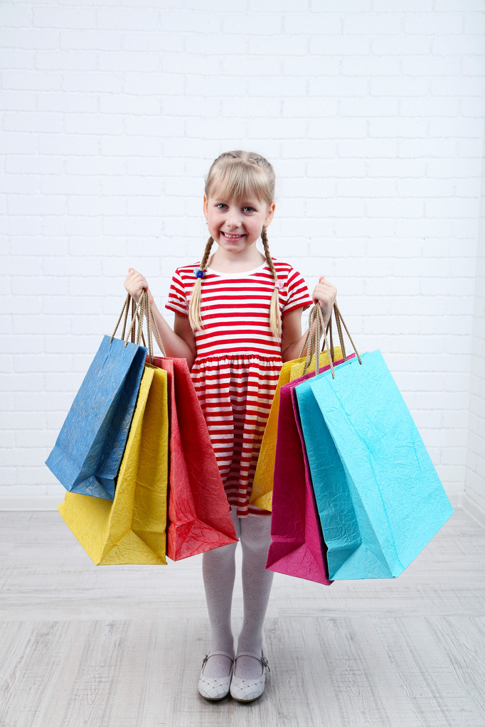 Alışveriş torbaları odasında güzel küçük kız - Fotoğraf, Görsel