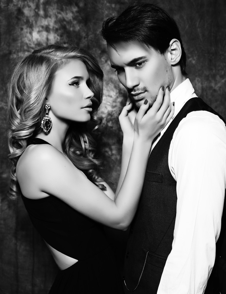 beautiful sensual couple in elegant clothes posing in studio  - Photo, Image