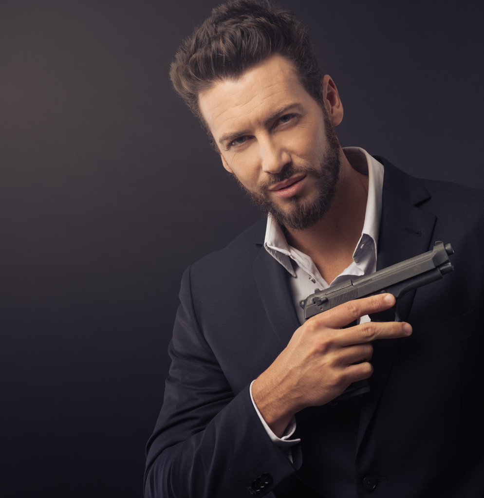 Confident undercover agent with a gun - Photo, Image