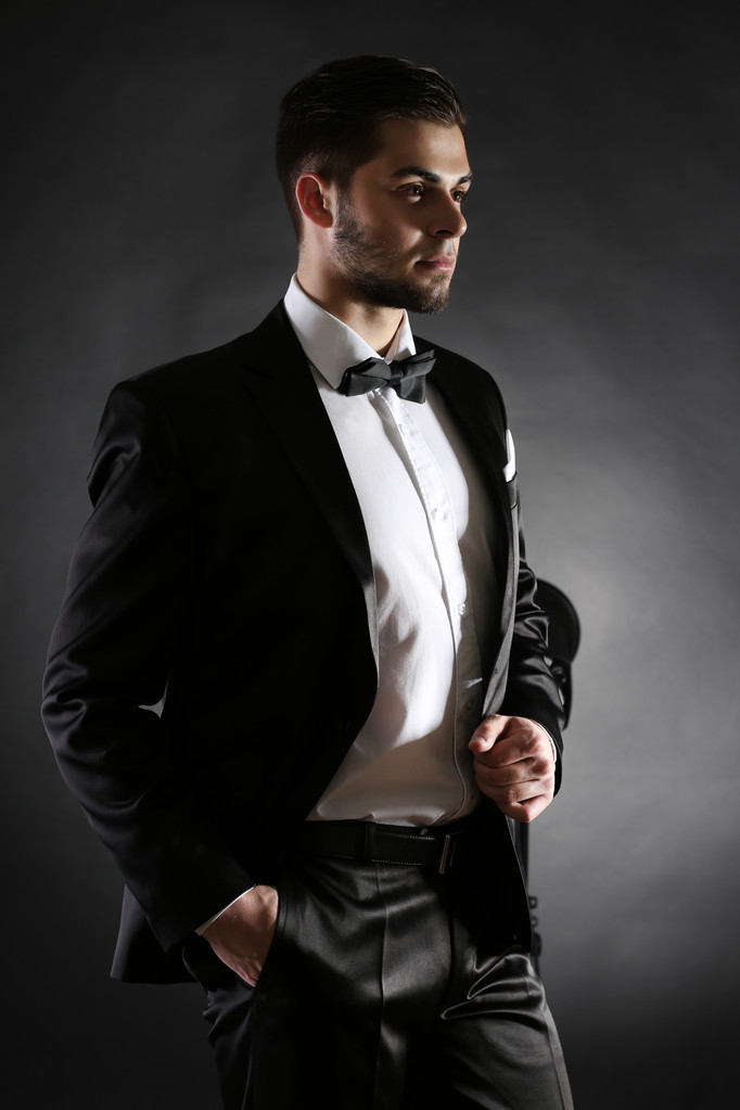 Elegant man in suit on dark background - Photo, Image