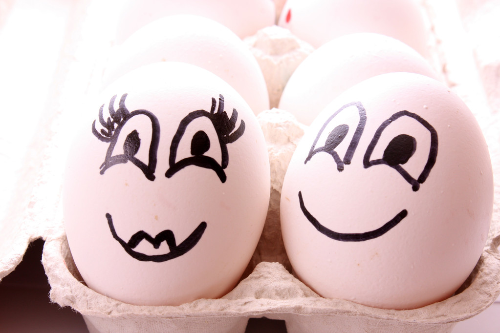 twee eieren met gezichten op wit - Foto, afbeelding