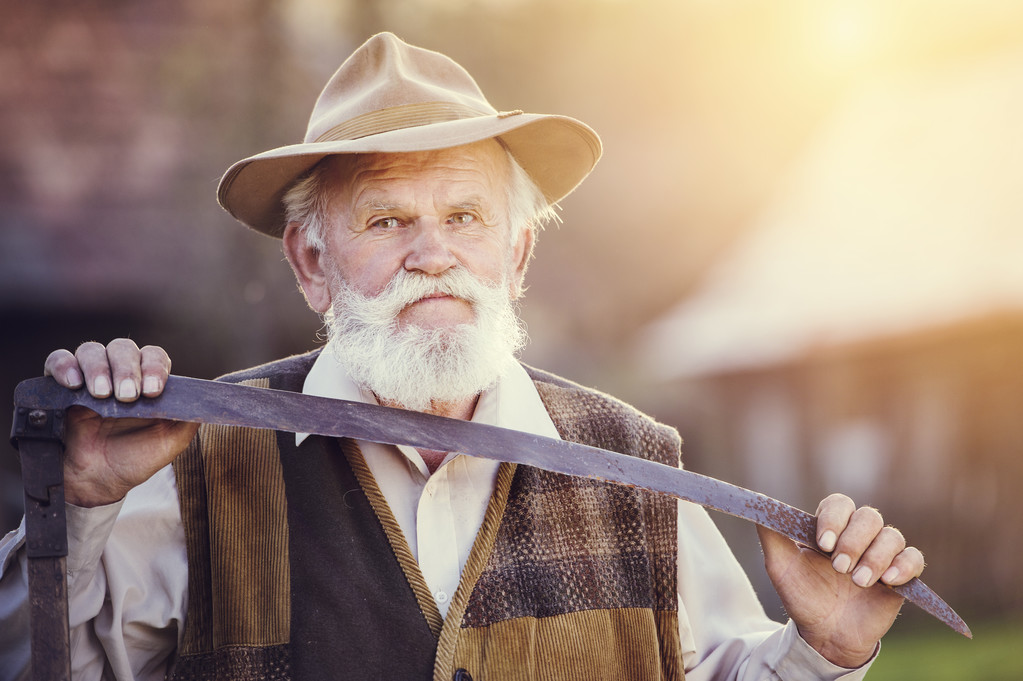 Old farmer with scythe taking a break - Photo, Image