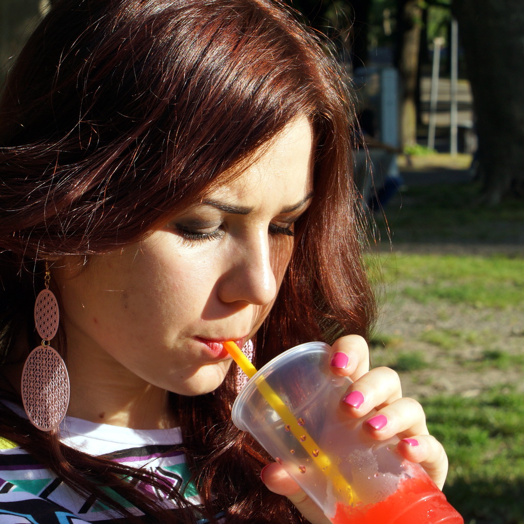Young lady eating slush in the park - Photo, Image