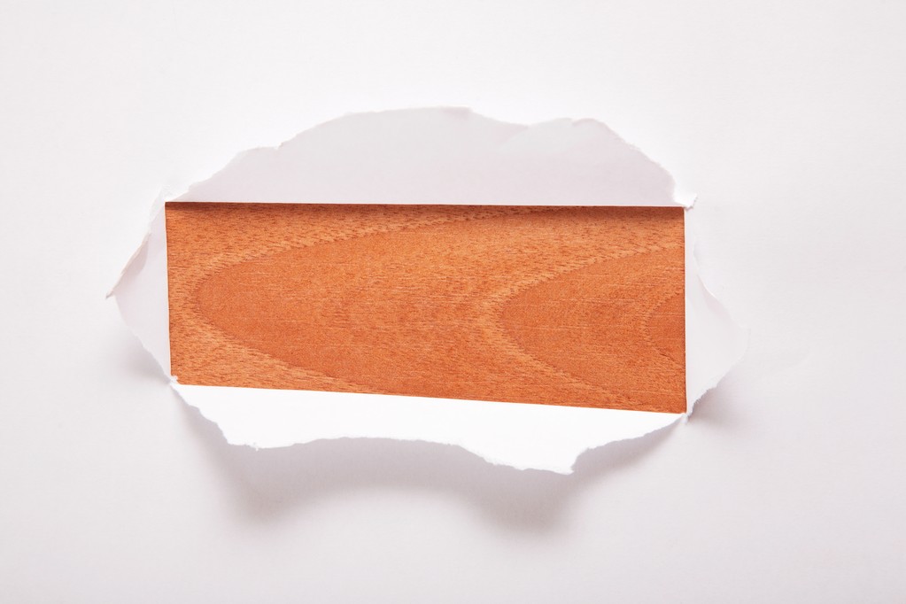 The sheet of paper with the rectangular hole against the wooden background - Photo, Image