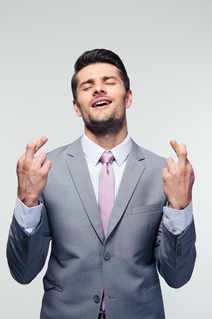 Businessman with fingers crossed - Photo, Image