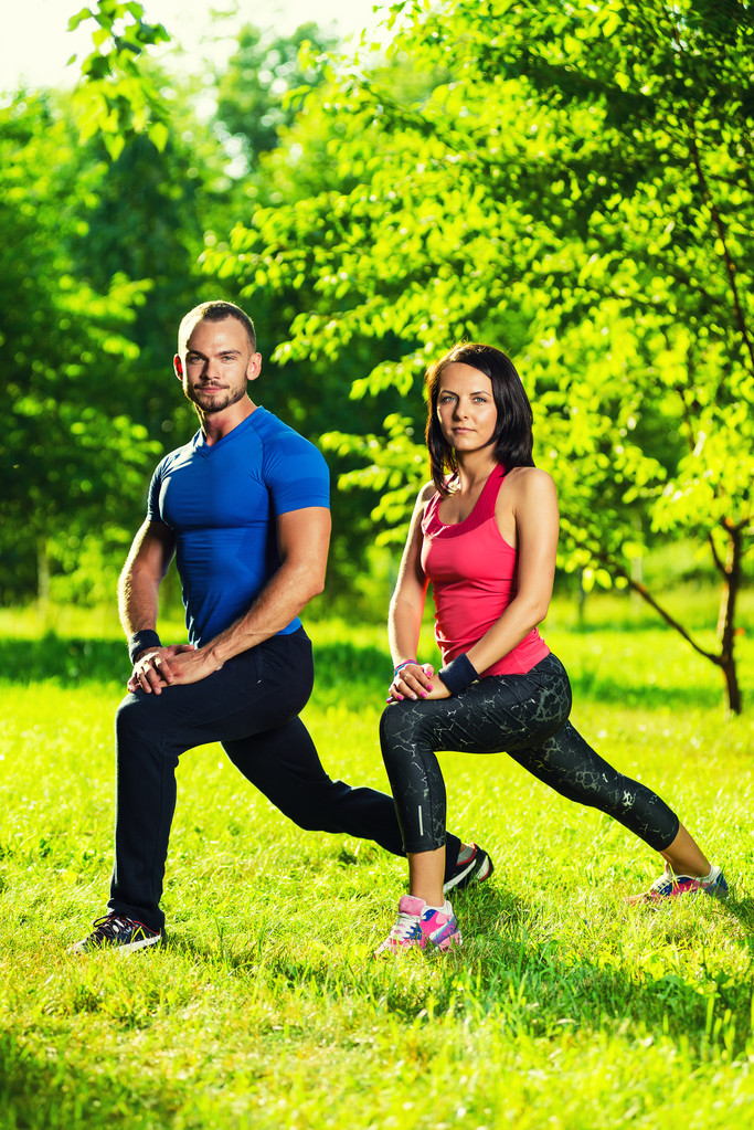 Άντρας και γυναίκα κάνουν ασκήσεις τεντώματος - Φωτογραφία, εικόνα