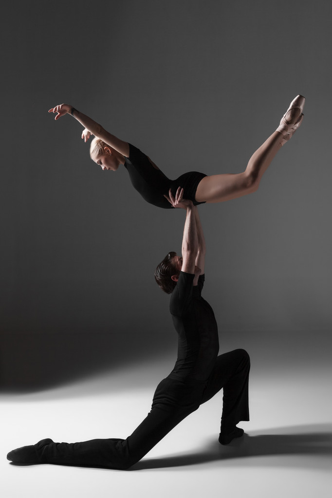 twee jonge modern balletdansers op grijze studio achtergrond  - Foto, afbeelding