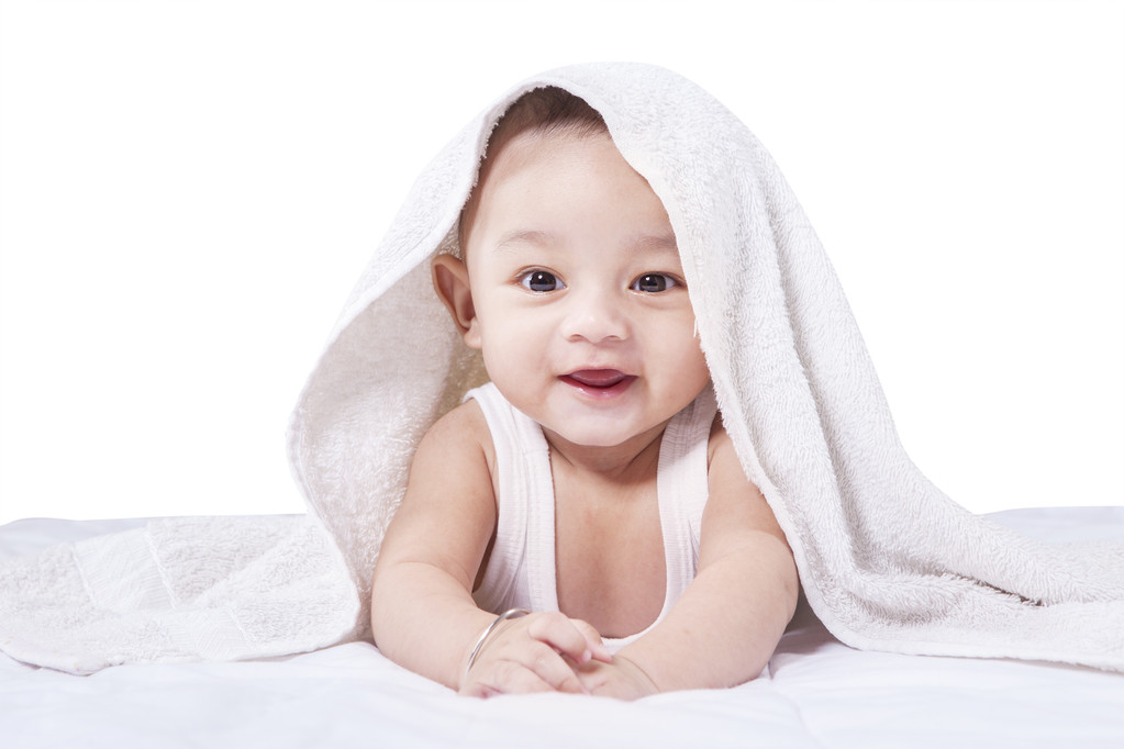 Male infant with towel on bed - Photo, Image