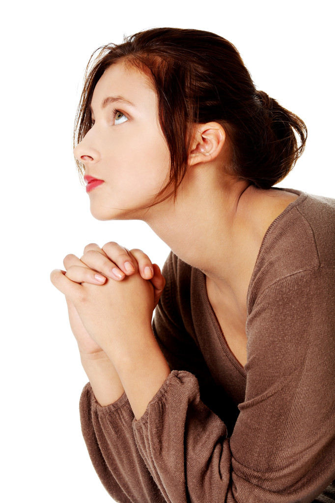 Chica joven rezando y mirando hacia arriba
. - Foto, imagen