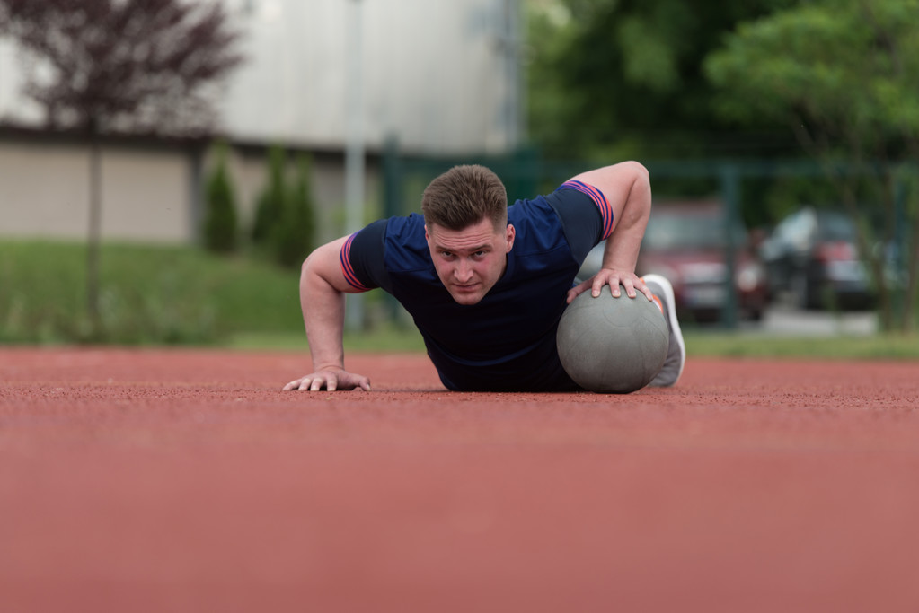 Young Man Exercising Push-Ups On Medicine Ball Outdoor - Φωτογραφία, εικόνα