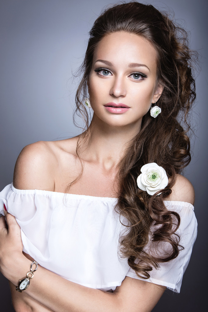 Portrait of a beautiful girl with flowers on her hair. Beauty face. Wedding image in the style boho - Photo, Image