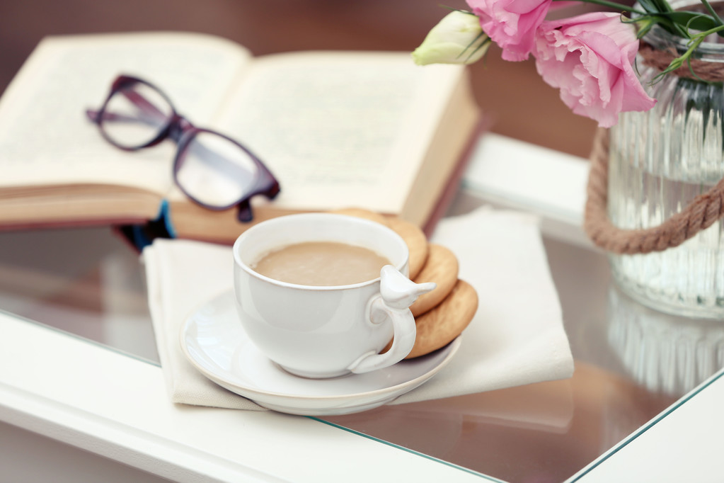 Cup of coffee with book on table in living room - Photo, Image