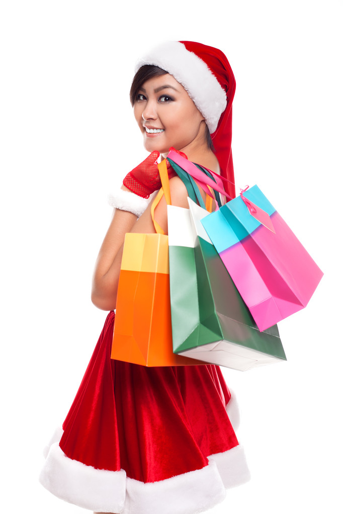 Świąteczne zakupy Azji kobieta myśli sobie santa hat i ho - Zdjęcie, obraz