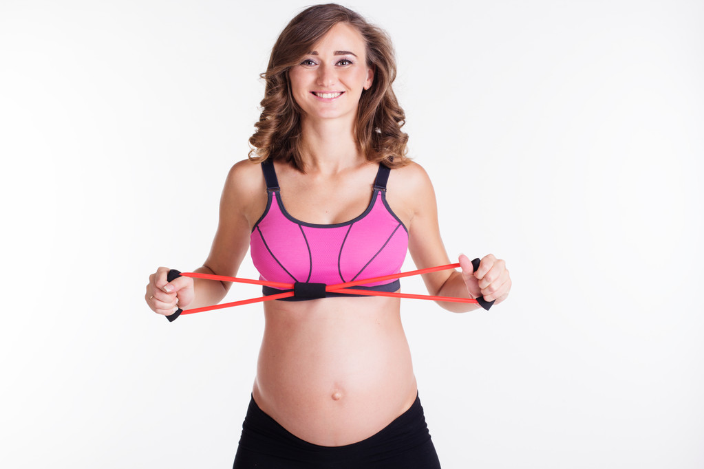 Zwangere vrouw doen stratching oefening - Foto, afbeelding