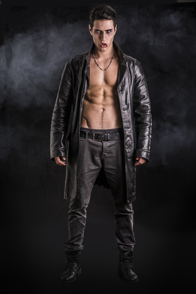 Young Vampire Man in an Open Black Leather Jacket, Showing his Chest and Abs - Photo, Image