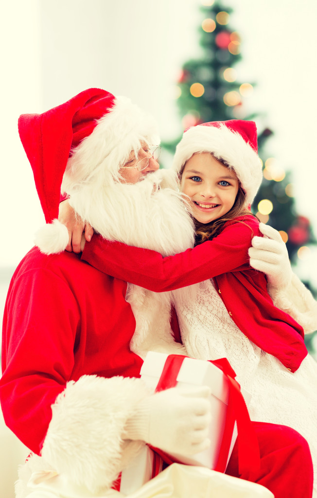 hymyilevä pieni tyttö joulupukin kanssa
 - Valokuva, kuva