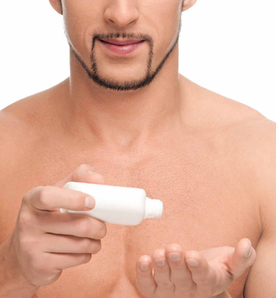 Young man applying cream. Cosmetic - Photo, Image