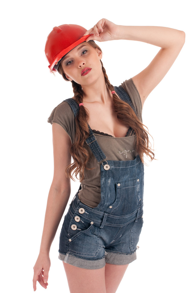 junge verspielte Arbeiterfrau in Overall und Helm - Foto, Bild