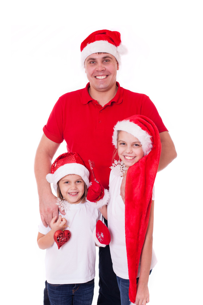 Gelukkig vader en twee dochters in santa's hoeden lachen - Foto, afbeelding