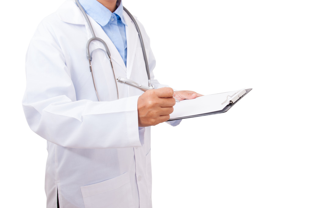Doctor writing on clipboard with pen - Photo, Image
