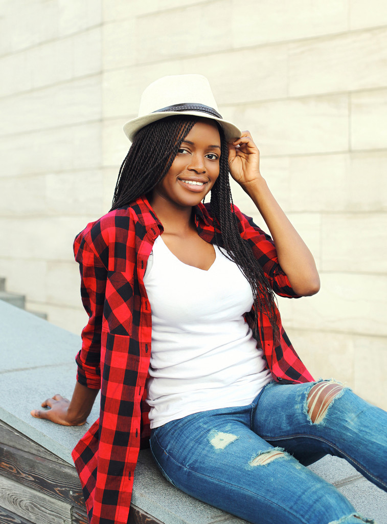 Fashion beautiful smiling african woman wearing a red checkered - 写真・画像