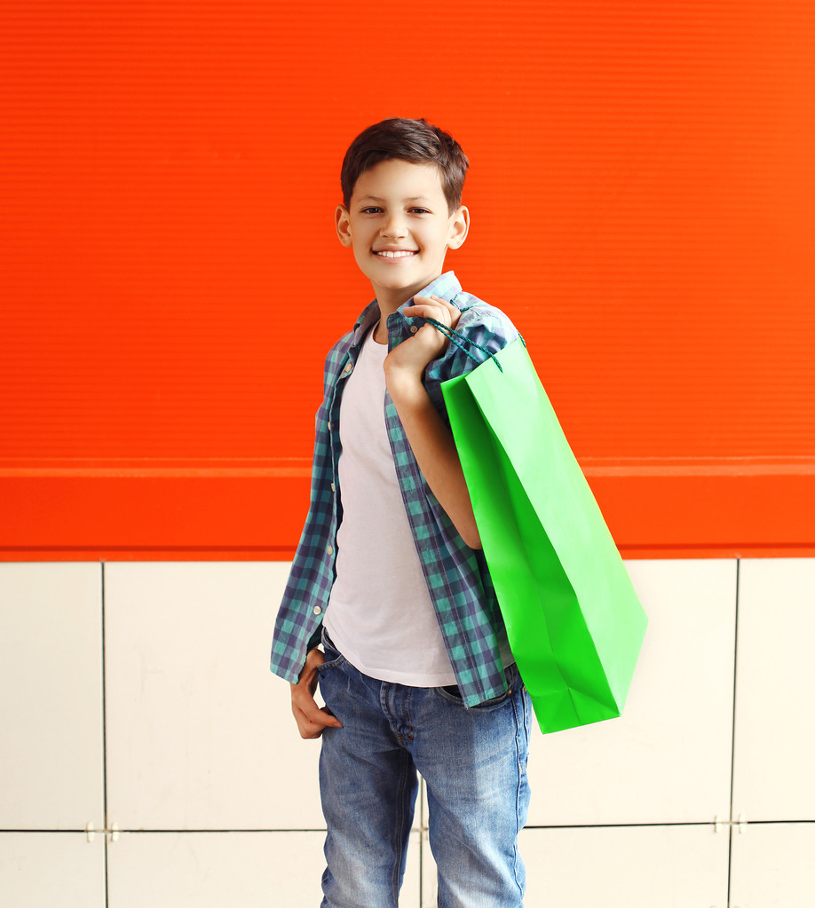 Portrait happy smiling little boy teenager with shopping bag in - Fotoğraf, Görsel