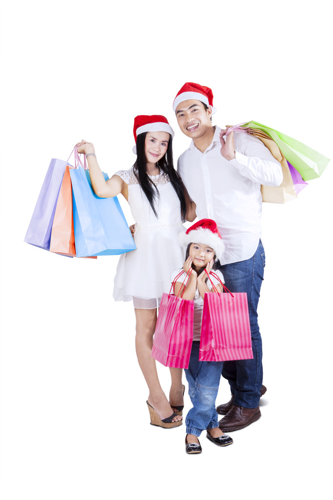 Семья с сумками для покупок и рождественской шляпой
 - Фото, изображение