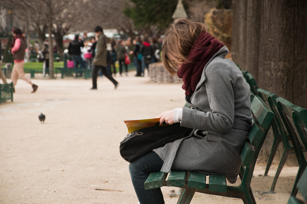 woman reading on bench in Notre dame garden - Photo, Image