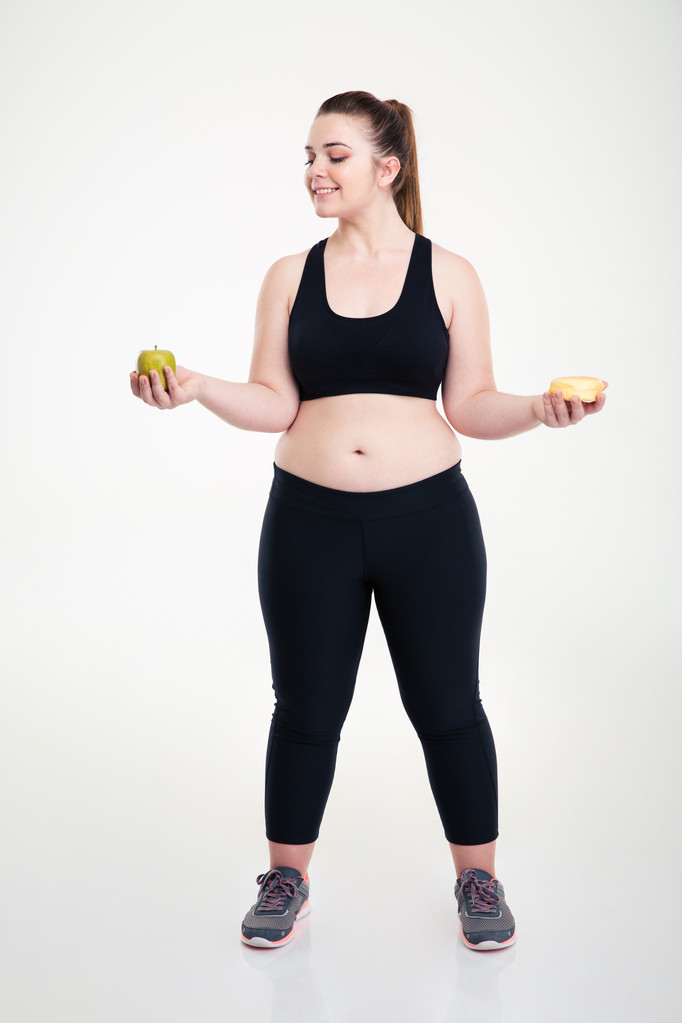 Fat woman choosing between donut and apple - Photo, Image