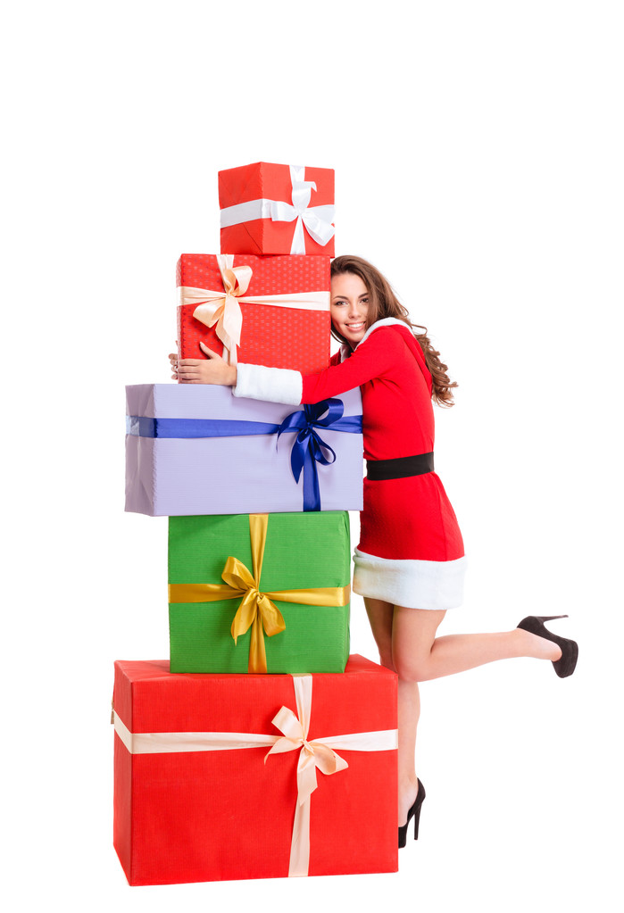 Onnellinen nainen joulupukin kankaalla halaamalla monia lahjapakkauksia
 - Valokuva, kuva